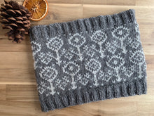 Load image into Gallery viewer, A cowl knit in gray Finn yarn with white Finn yarn as the contrast color in a flower-patterned colorwork motif.
