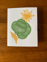 Load image into Gallery viewer, A card with a linocut design of a green skein and a yellow flower behind it.
