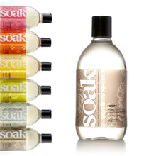 Load image into Gallery viewer, A 12 oz bottle of Soak, scent Lacey. The other scents are shown to the left.
