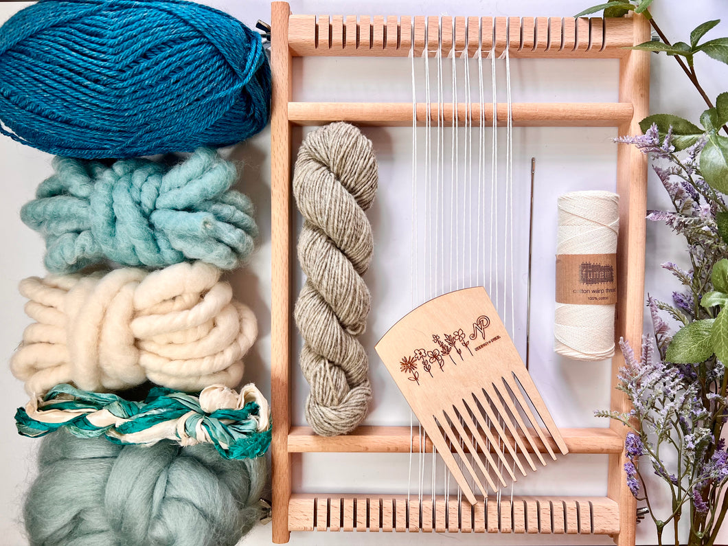 A handheld tapestry loom, tools and fibers