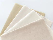 Load image into Gallery viewer, Four fat quarters in cotton and linen-cotton fabrics, in neutral colors.
