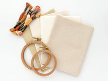Load image into Gallery viewer, Four fat quarters of cotton and linen-cotton fabrics in neutral colors, with wood embroidery hoops and cotton threads.
