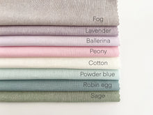 Load image into Gallery viewer, A stack of 8 linen-cotton blend fabrics, labeled from top to bottom as fog, lavender, ballerina, peony, cotton, powder blue, robin egg and sage.
