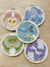 Load image into Gallery viewer, Five circular wood embroidery hoops with distinct embroidered designs of Northern owls in reds, blues, greens, and purples.
