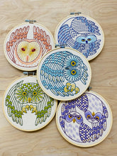 Load image into Gallery viewer, Five embroidery hoops hold various images of Northern owls in reds, yellows, greens and blues.
