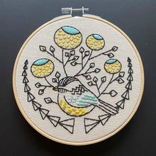Load image into Gallery viewer, An embroidery hoop with a pattern of a chickadee and flowers in blue, yellow and black threads.
