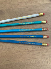 Load image into Gallery viewer, A set of five pencils in white and shades of blue, with the words &quot;Reorganizing My Knits&quot; in gold lettering.
