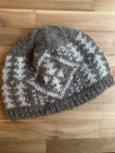 Load image into Gallery viewer, A colorwork hat in dark gray marled yarn with white contrast color motif in geometric triangles and diamond pattern.
