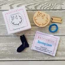 Load image into Gallery viewer, A Katrinkles small darning loom box and contents - the rounded wood darning loom, wood heddle teeth, needle and felt sock holder, fabric elastic band, and instructions.
