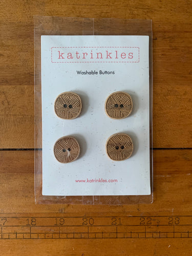 A four-pack of wood Katrinkles buttons etched with geometric lines.