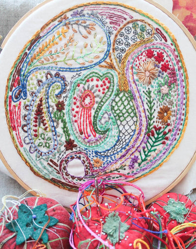 A hand-embroidered piece featuring colorful paisley patterns.