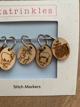 Load image into Gallery viewer, A set of 6 stitch markers made of wood, etched with pictures of 6 rare sheep breeds.
