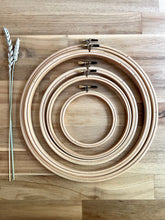 Load image into Gallery viewer, Five wood embroidery hoops - sizes 4&quot;, 6&quot;, 7&quot;, 9&quot; and 10&quot; - with brass closures.
